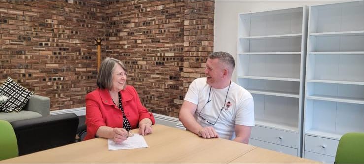 Fiona Bruce MP sitting with founder Scott Glover, discussing Leg8cy's music-led mental-health work