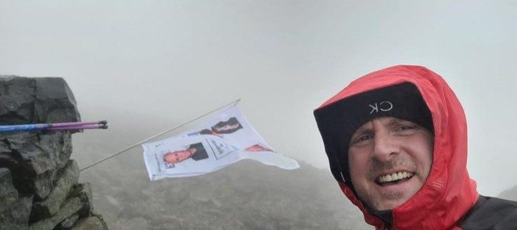 Two walkers in the rain, hoods up, on a fundraising walk