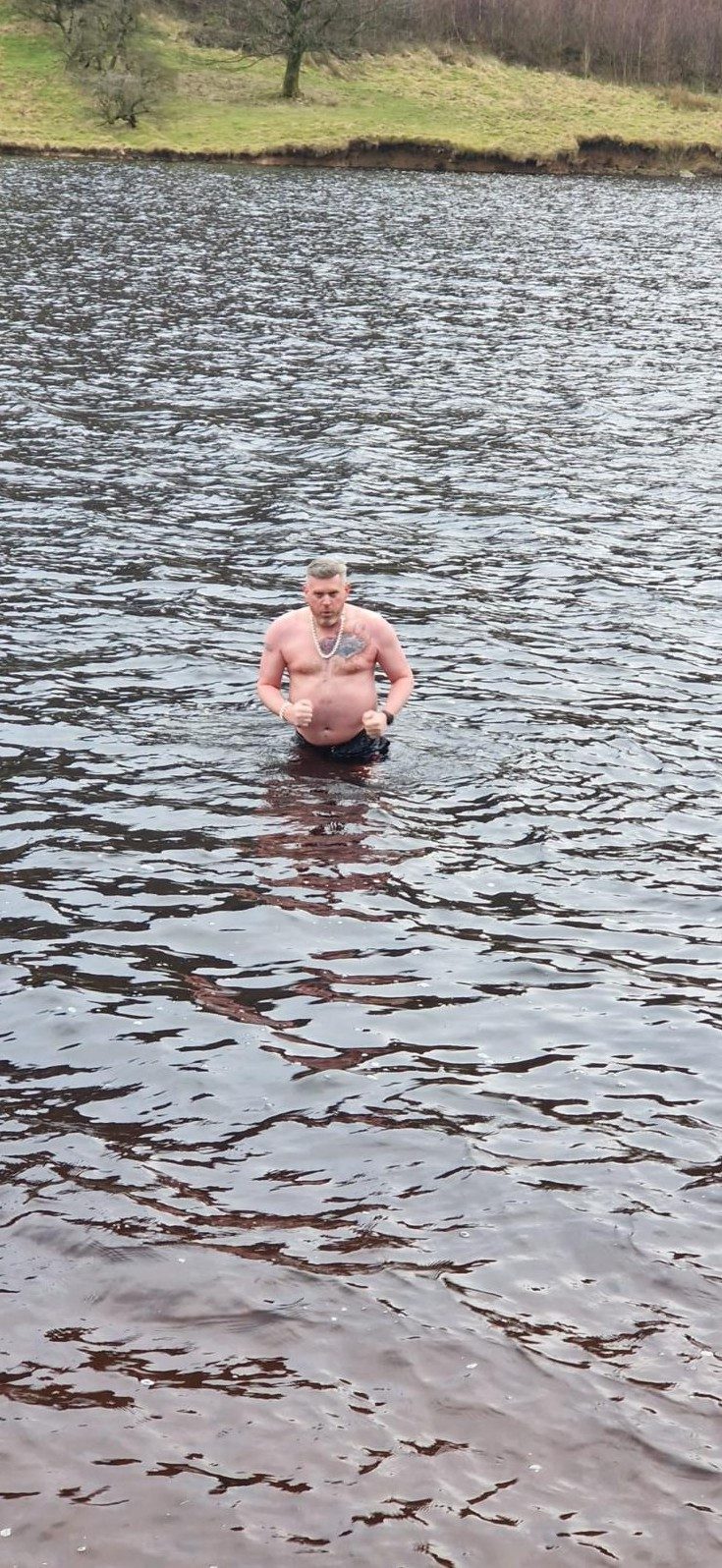 Scott taking a cold-water swim in a lake
